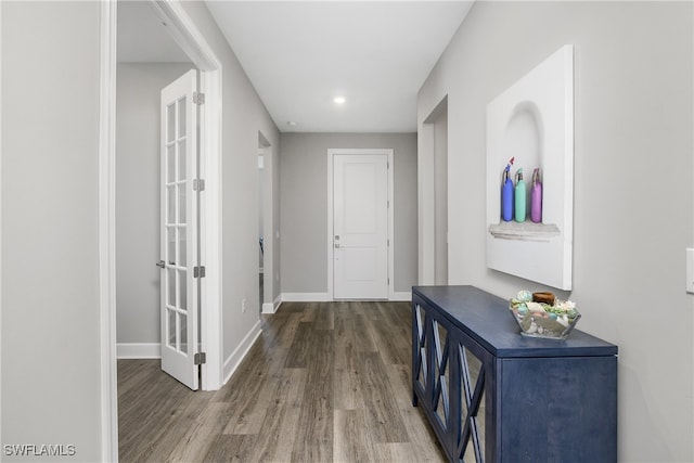 corridor with hardwood / wood-style flooring