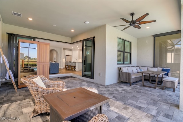 view of patio featuring an outdoor living space and ceiling fan