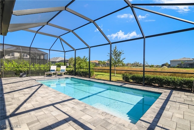 view of pool with a patio area and a lanai