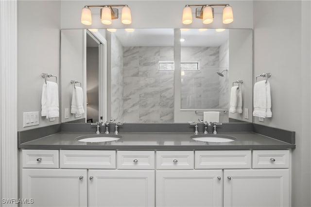 bathroom featuring vanity and tiled shower