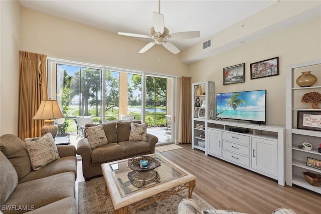 living room featuring ceiling fan and light hardwood / wood-style flooring