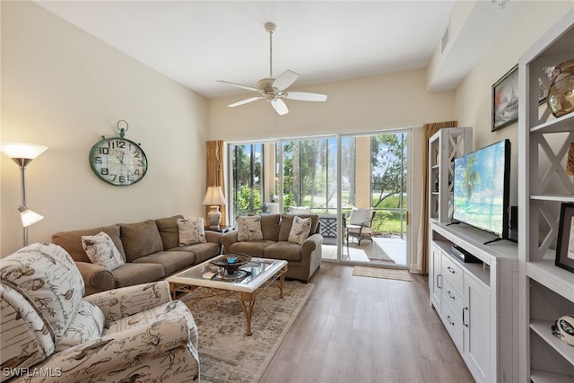 living room with ceiling fan and light hardwood / wood-style flooring