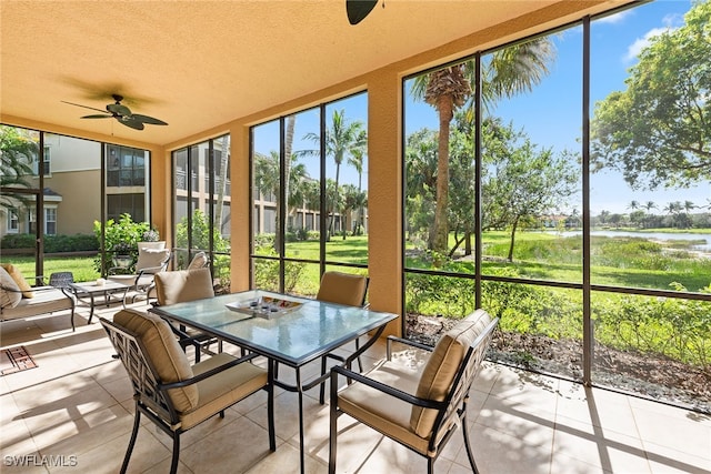 sunroom / solarium featuring ceiling fan