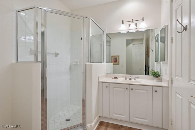 3053 Aviamar Cir Unit 101, Naples, FL 34114 - bathroom with vanity, a stall shower, and wood finished floors