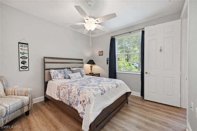 bedroom with ceiling fan and light hardwood / wood-style flooring