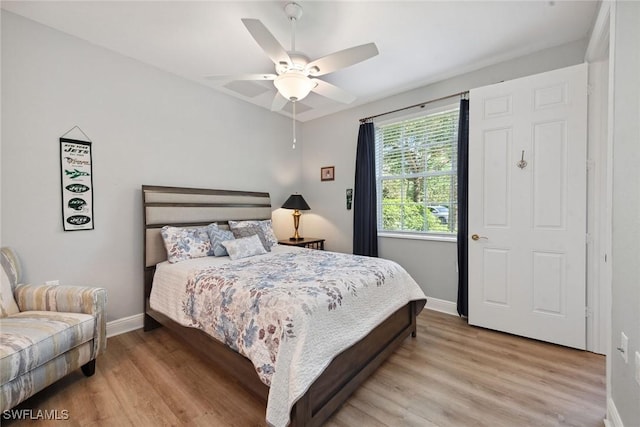 3053 Aviamar Cir Unit 101, Naples, FL 34114 - bedroom with light wood finished floors, baseboards, and ceiling fan