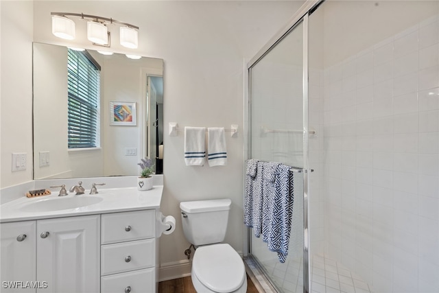 bathroom with vanity, toilet, and an enclosed shower