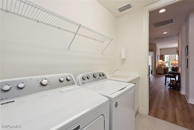 3053 Aviamar Cir Unit 101, Naples, FL 34114 - washroom featuring independent washer and dryer, light tile patterned floors, recessed lighting, and baseboards