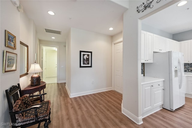 hallway with light hardwood / wood-style flooring