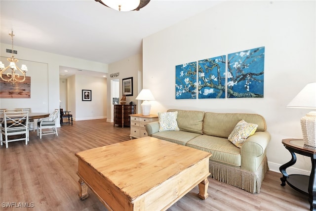 living room featuring a notable chandelier and hardwood / wood-style flooring