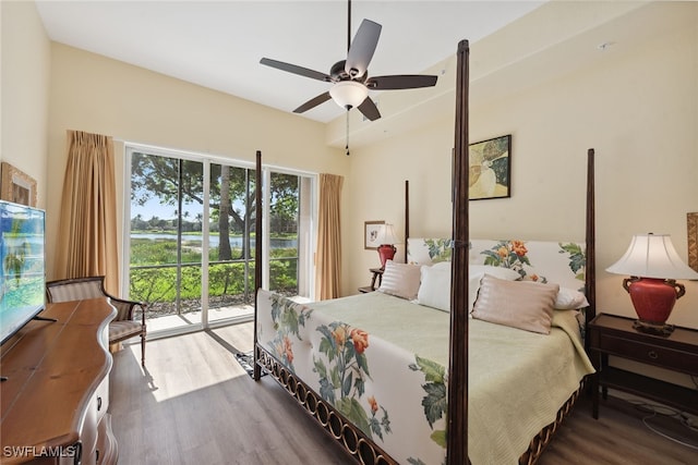 bedroom with multiple windows, ceiling fan, hardwood / wood-style floors, and access to exterior