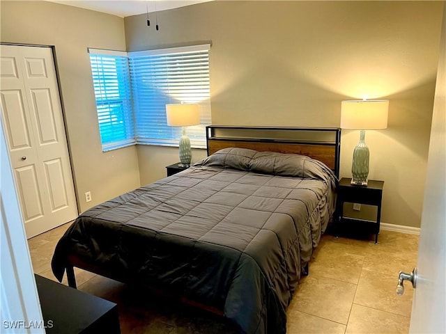 tiled bedroom featuring a closet