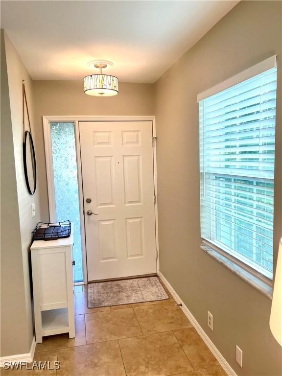 tiled entrance foyer with a wealth of natural light