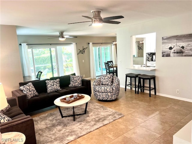 tiled living room with ceiling fan