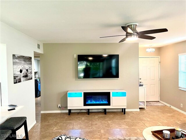 living room with light tile patterned flooring and ceiling fan