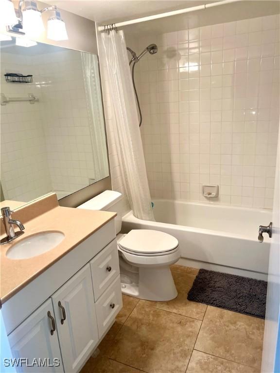 full bathroom featuring tile patterned flooring, vanity, shower / tub combo, and toilet