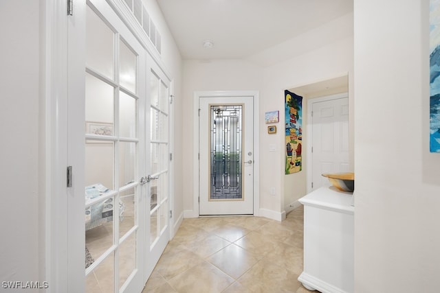 foyer entrance with french doors and light tile patterned floors