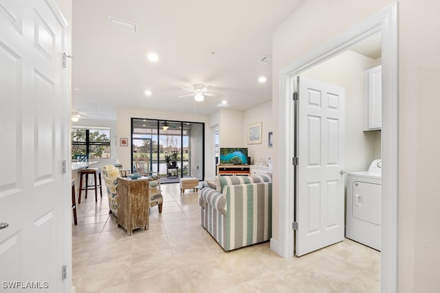 tiled living room with washer / clothes dryer and ceiling fan