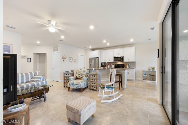 living room featuring ceiling fan and light tile patterned flooring