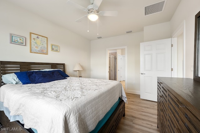 bedroom with ceiling fan, wood-type flooring, and connected bathroom