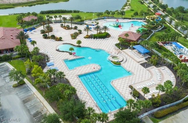 view of pool featuring a water view