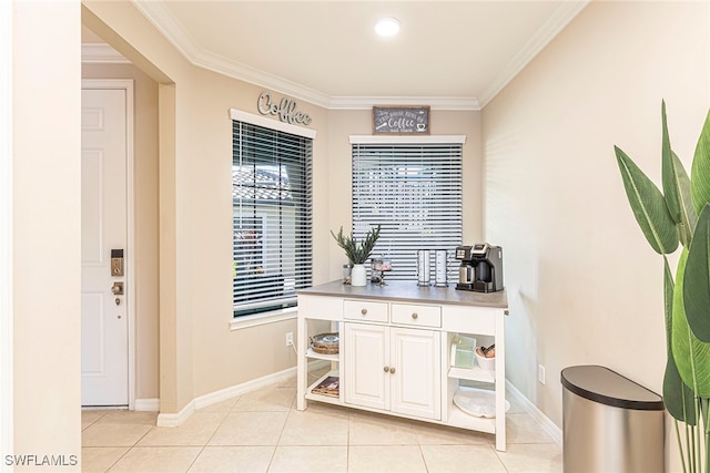 interior space featuring white cabinetry, crown molding, and light tile patterned floors