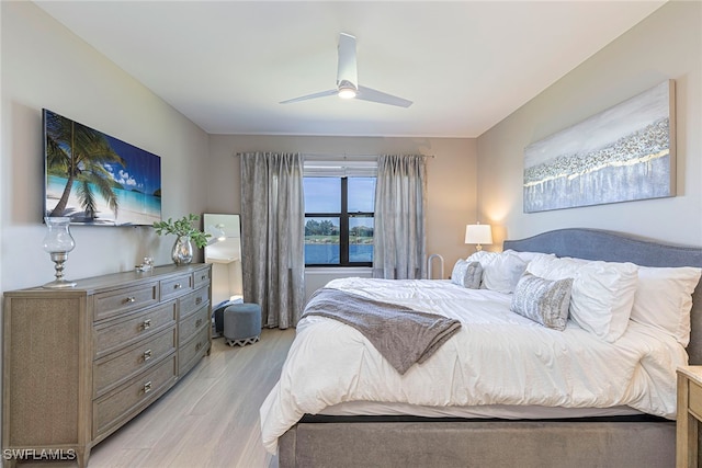 bedroom with light hardwood / wood-style floors and ceiling fan