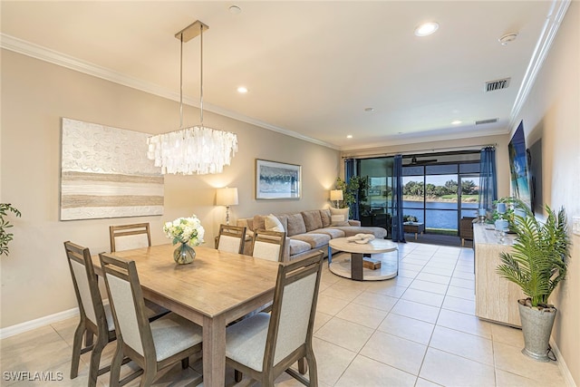 tiled dining space with crown molding and an inviting chandelier