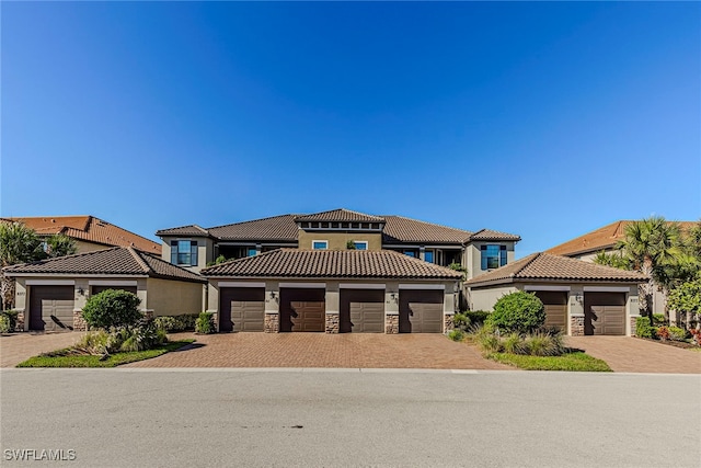 mediterranean / spanish home featuring a garage