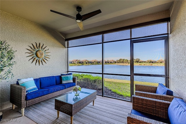 sunroom featuring a wealth of natural light, a water view, and ceiling fan