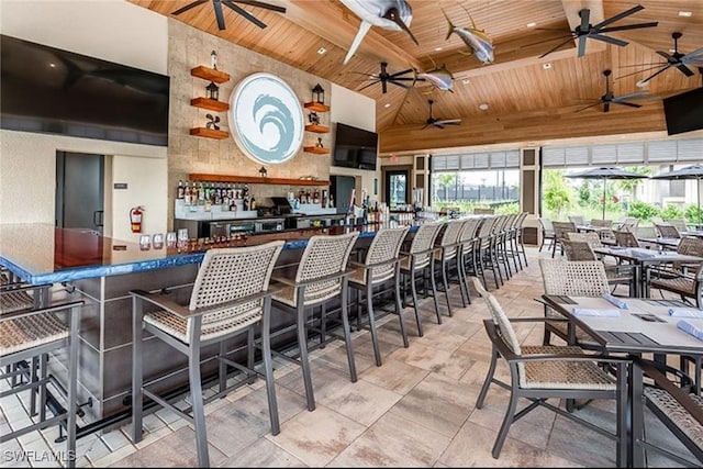 interior space featuring high vaulted ceiling, wood ceiling, and indoor bar