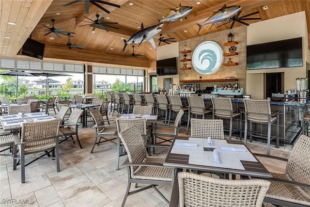 dining room featuring wood ceiling and high vaulted ceiling