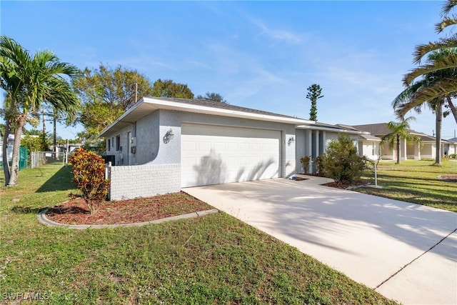 ranch-style home with a garage and a front lawn