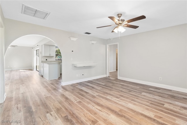 unfurnished living room with light hardwood / wood-style flooring and ceiling fan