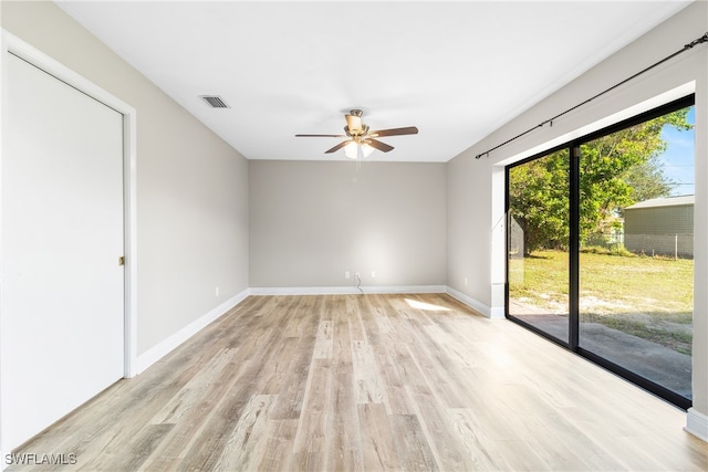 unfurnished room with ceiling fan and light wood-type flooring