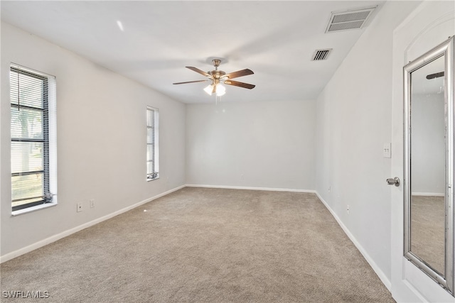 carpeted empty room with ceiling fan