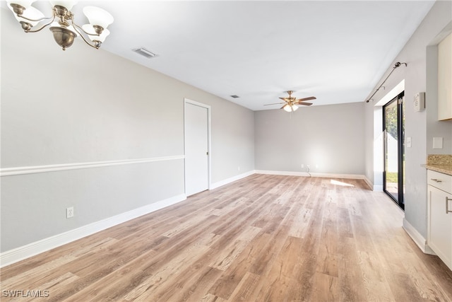 interior space with light hardwood / wood-style flooring and ceiling fan with notable chandelier