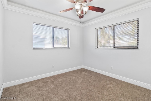 empty room featuring carpet floors, plenty of natural light, crown molding, and ceiling fan