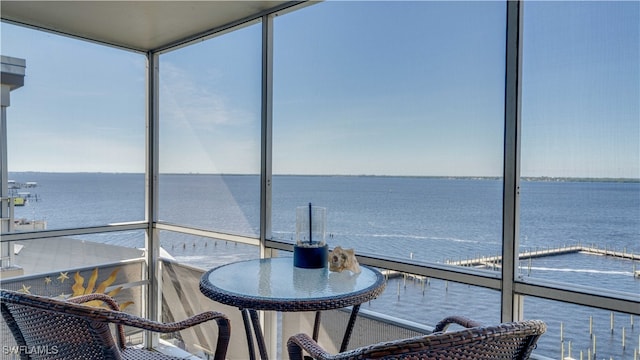 sunroom / solarium with a water view