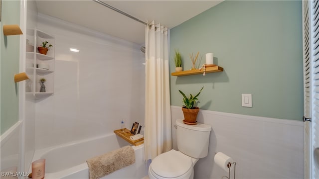 bathroom featuring shower / bath combo and toilet