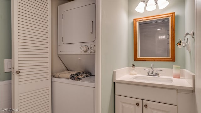 bathroom with stacked washer / dryer and vanity