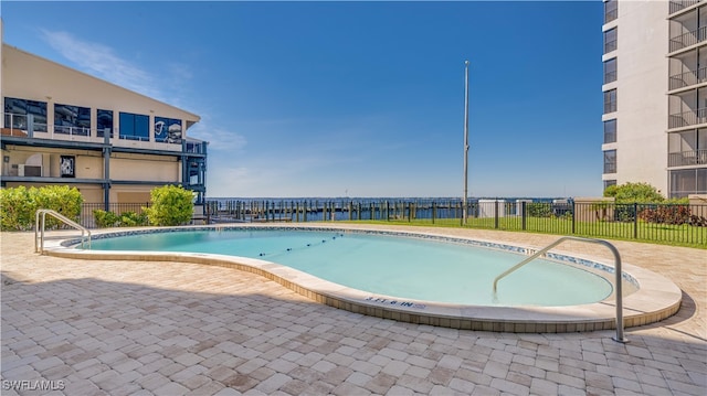 pool featuring fence and a patio