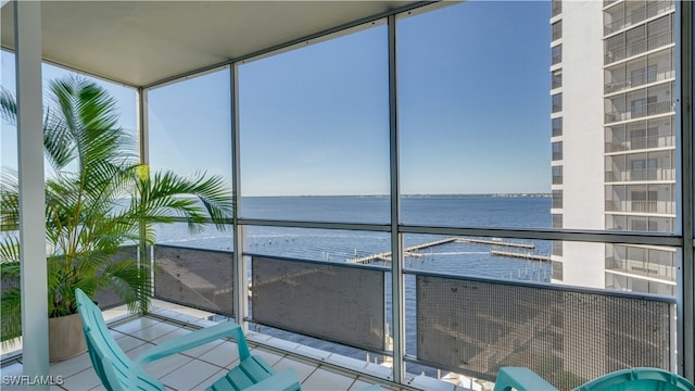 unfurnished sunroom with a water view