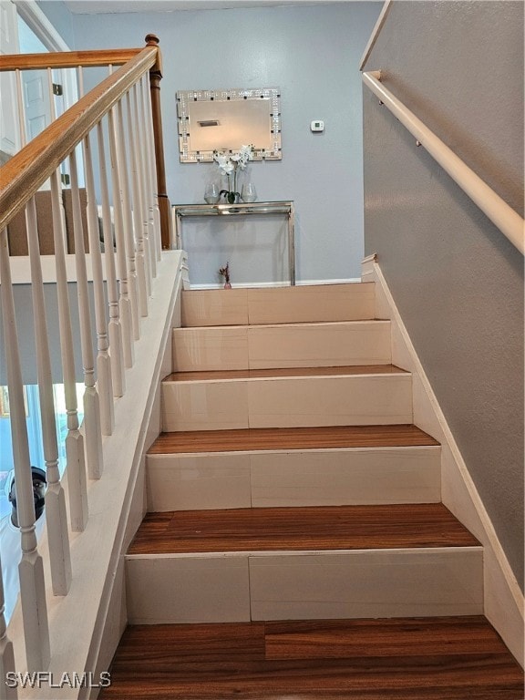 stairs with hardwood / wood-style floors