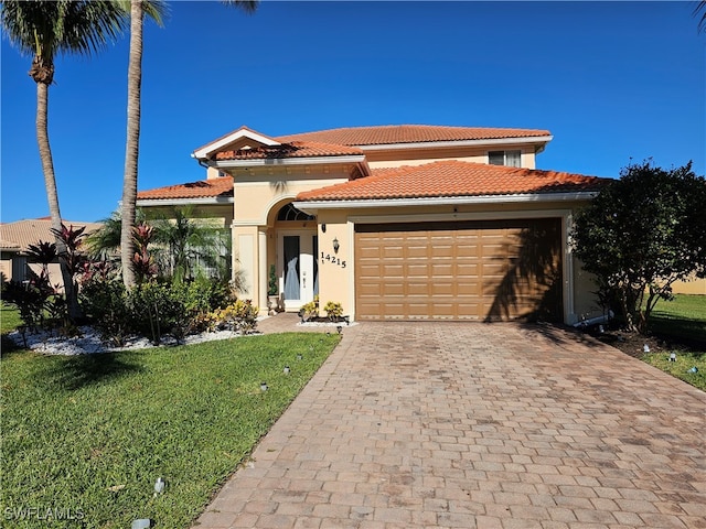 mediterranean / spanish-style house featuring a front lawn and a garage