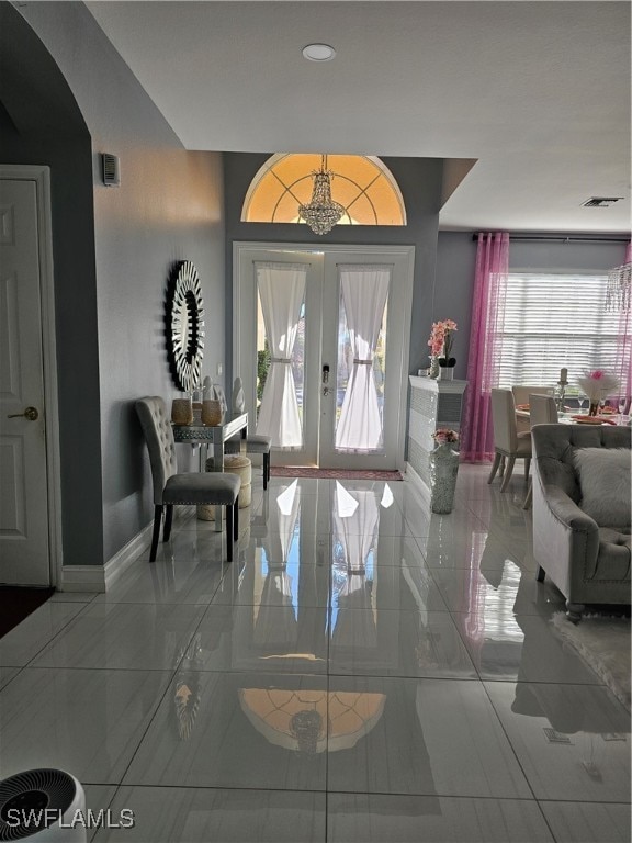 foyer entrance with a healthy amount of sunlight and french doors