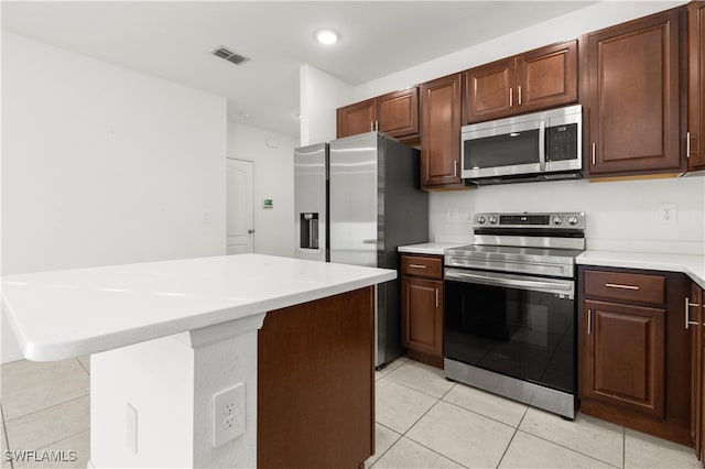 kitchen with light tile patterned floors and appliances with stainless steel finishes