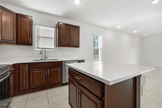 kitchen featuring black stove, stainless steel dishwasher, sink, light tile patterned floors, and a center island