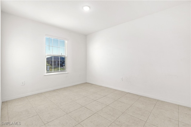 spare room featuring light tile patterned floors