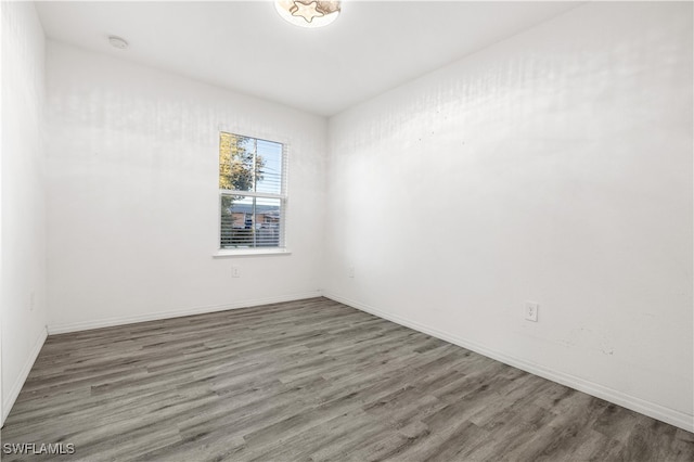 spare room with dark hardwood / wood-style floors